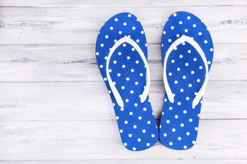 Color flip-flops on wooden background