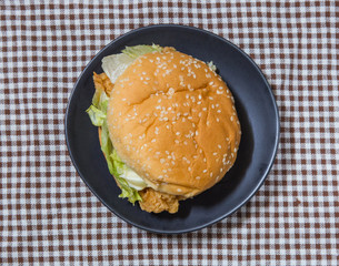 hamburger with chicken on table