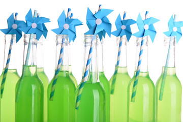 Bottles of drink with straw isolated on white