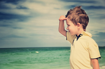 toned image boy looking away from his palm on the background of