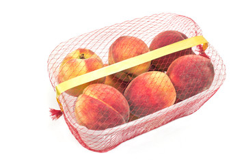 Fresh peaches in plastic bowl isolated on white