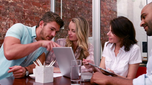 Casual business team having a meeting with laptop