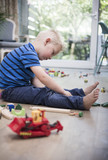 Boy playing with toys on the floor