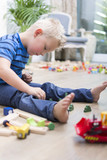 Boy playing with toys on the floor