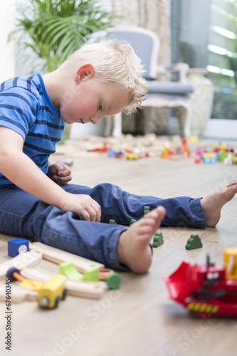 Boy playing with toys on the floor