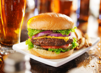 hamburger with fries and beer shot in panorama style