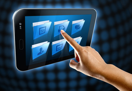 a woman's finger, selects a folder on a tablet screen