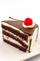 Chocolate cake slice with red cherry fruit.