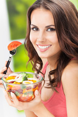 Young woman with salad, outdoors