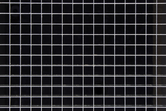 Iron protection grate over the manhole on the pavement