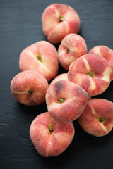 Stack of ripe donut peaches, high angle view
