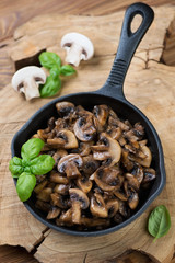 Cast-iron frying pan with roasted mushrooms, high angle view