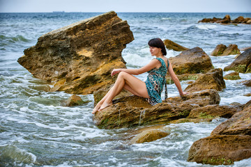 woman on rock in beach