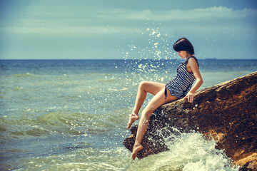 woman on rock in beach