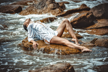 woman on rock in beach