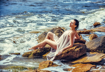 woman on rock in beach
