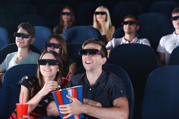 Obraz premium Young people watching movie in cinema