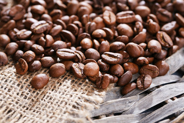 Coffee beans on wicker mat background