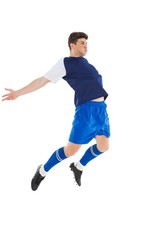Fototapeta na wymiar Football player in blue jersey jumping