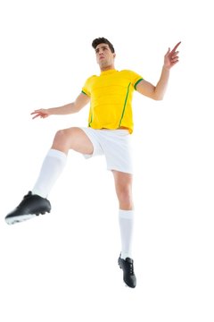 Football Player In Yellow Jersey Kicking