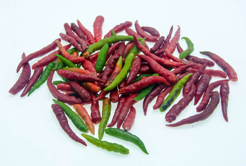 Red and green chilli peppers on white background