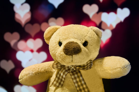 Lovely teddy bear with love bokeh background