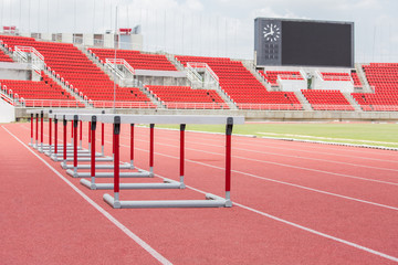 hurdles on the red running track