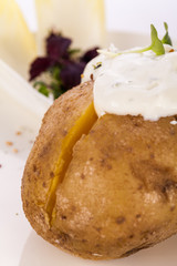 Baked jacket potato with sour cream sauce