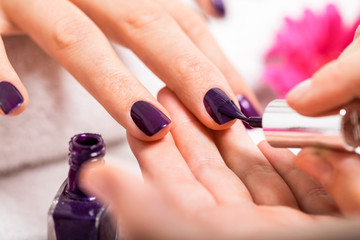 Woman having a nail manicure in a beauty salon