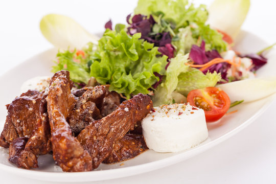 grilled beef stripes fresh salad and goat cheese