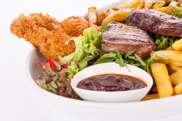 Platter of mixed meats, salad and French fries