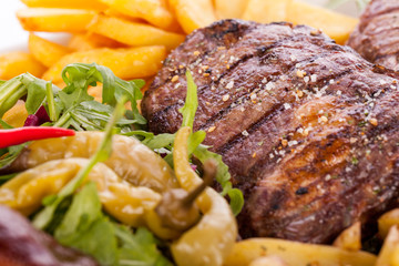 Platter of mixed meats, salad and French fries