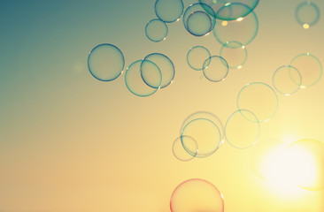 Soap bubbles floating in the air as the Summer sunsets - 67673347