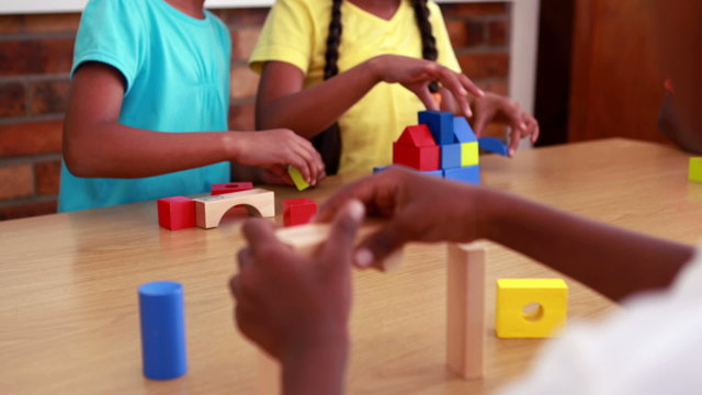 Pupils playing with building blocks in classroom