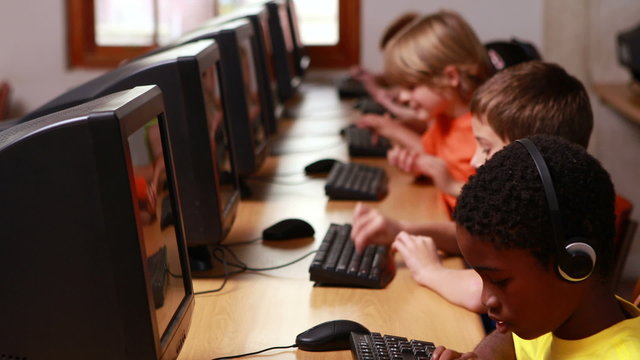 Row of pupils working in computer class