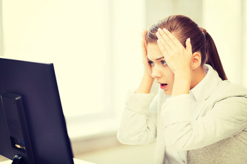 stressed student with computer in office