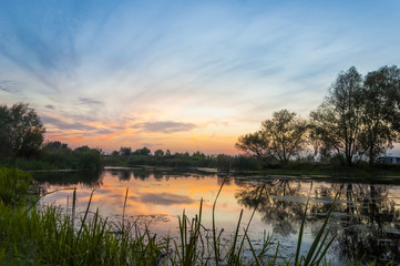 Obraz na płótnie Canvas landscape sunset on the river
