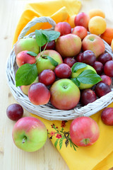 Fresh fruits with leaves in basket.