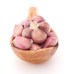 Garlic cloves in wooden bowl isolated on white background