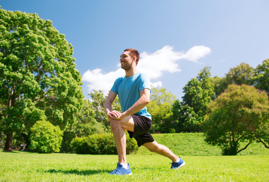 smiling man stretching outdoors