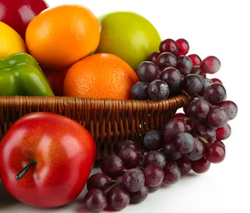 Different fruits and vegetables in basket isolated on white