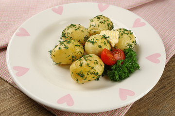 Young boiled potatoes on table, close up