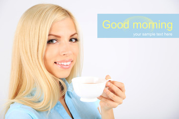 Young beautiful woman with cup of tea isolated on white