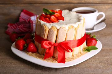 Tasty cake Charlotte with fresh strawberries on wooden table