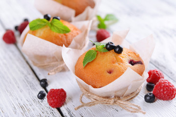 Tasty cupcakes with fruits on table close-up