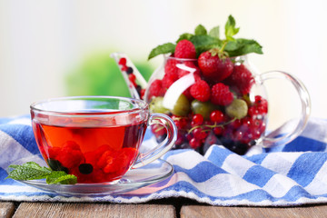 Fruit red tea with wild berries in glass cup,