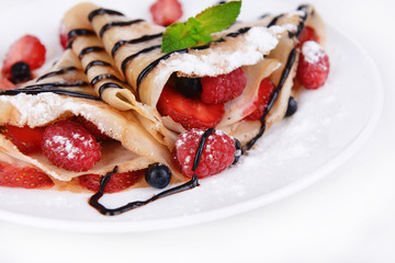 Delicious pancakes with berries isolated on white