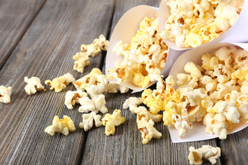 Popcorn on wooden table, close up