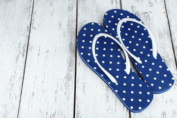 Color flip-flops on wooden background