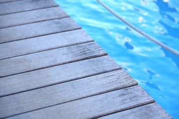 Fototapeta premium Wooden bridge on way to harbor, close-up